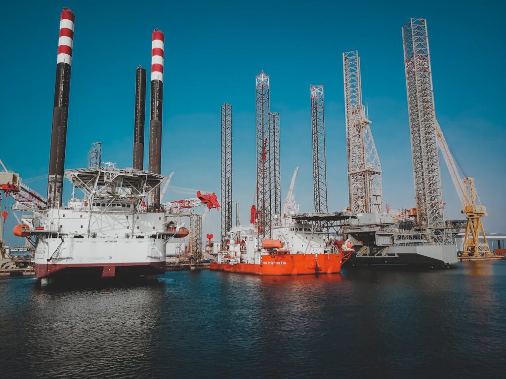 Jack-up drilling rigs and support vessels moored in a harbour