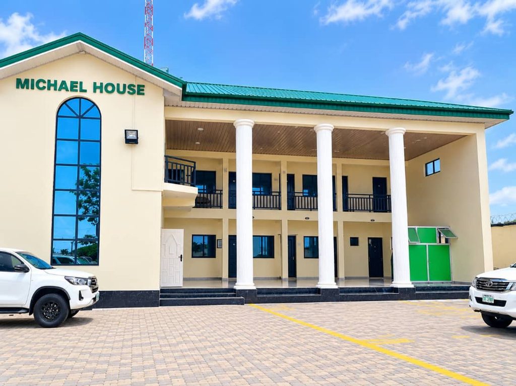 Michael House, a two-storey office building with white pillars and a green roof