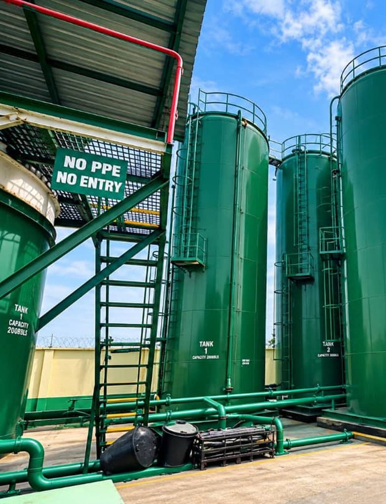 No PPE, No Entry safety sign at the stair to the green storage tanks