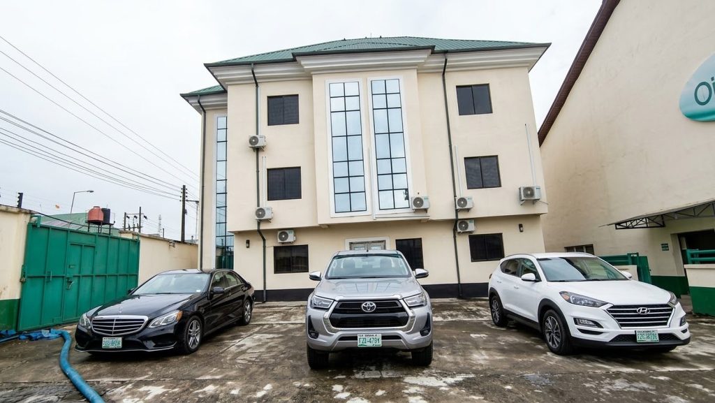 Oilchem's three-storey office building, with cars parked in front